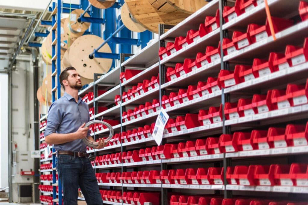 Man Stood in Warehouse Looking at Racking